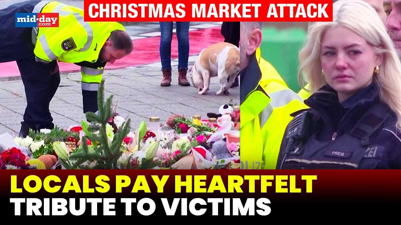 Locals pay emotional tribute to victims of Christmas market attack